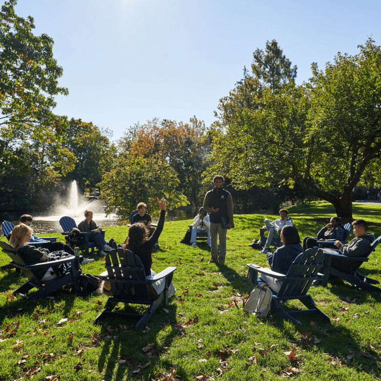 Teachers and students having a class discussion outside